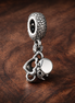 White Flower Charm - White Open Petal Flower Charm — display on walnut