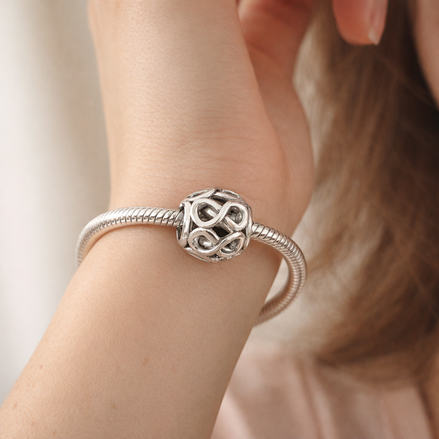 Openwork Infinity Charm — worn on wrist