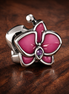 Magenta Orchid Charm - Magenta Orchid Flower Charm — display on walnut