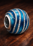 Blue Wave Charm — display on walnut
