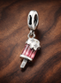 Sprinkled Popsicle Dangle Charm — display on walnut