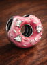 Sparkling Sprinkled Donut Charm — display on walnut