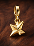 Gold Plated Origami Bird Charm - Gold Plated Origami Crane Dangle Charm — display on walnut