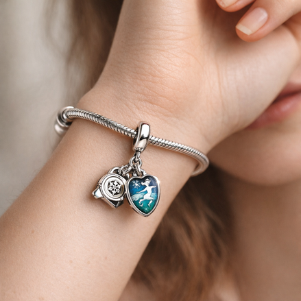 Camera, Heart & Compass Triple Dangle Charm — worn on wrist