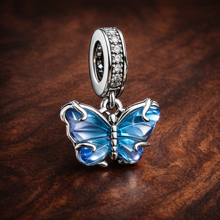 Blue Murano Glass Butterfly Dangle Charm — display on walnut