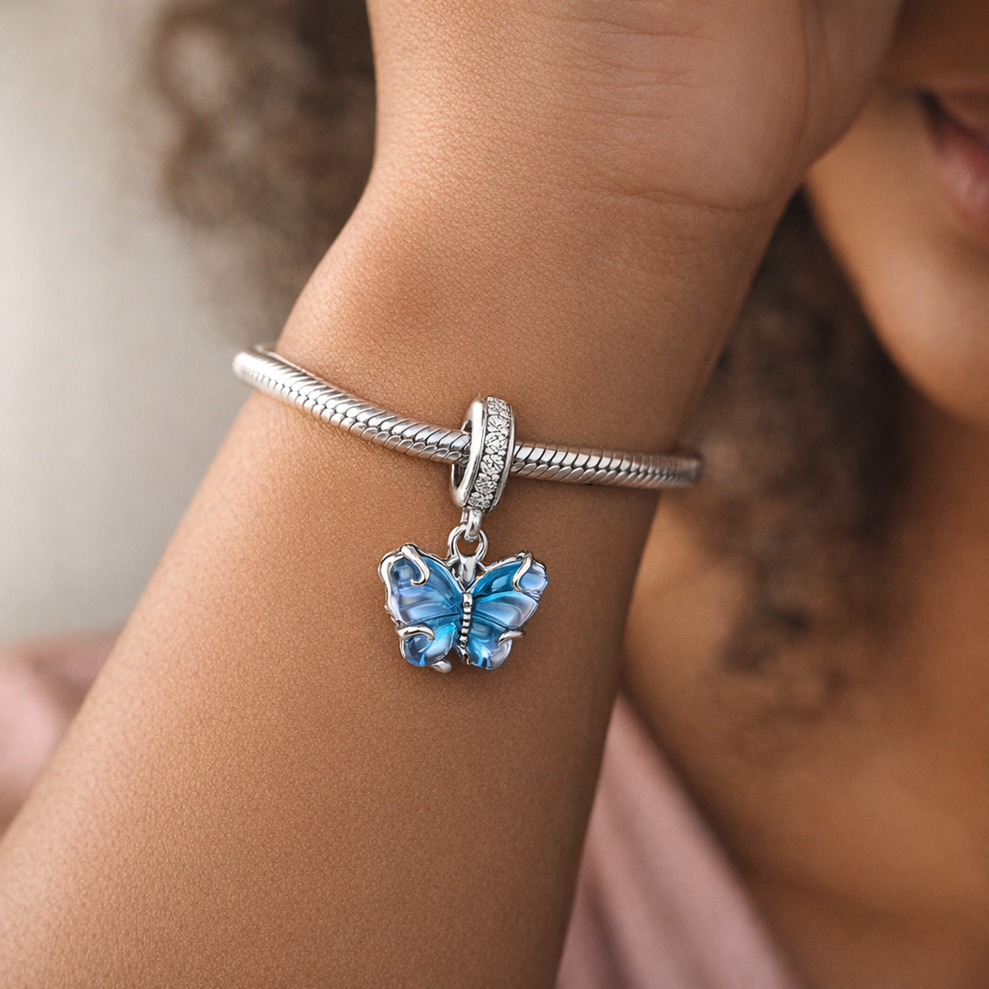 Blue Murano Glass Butterfly Dangle Charm — worn on wrist