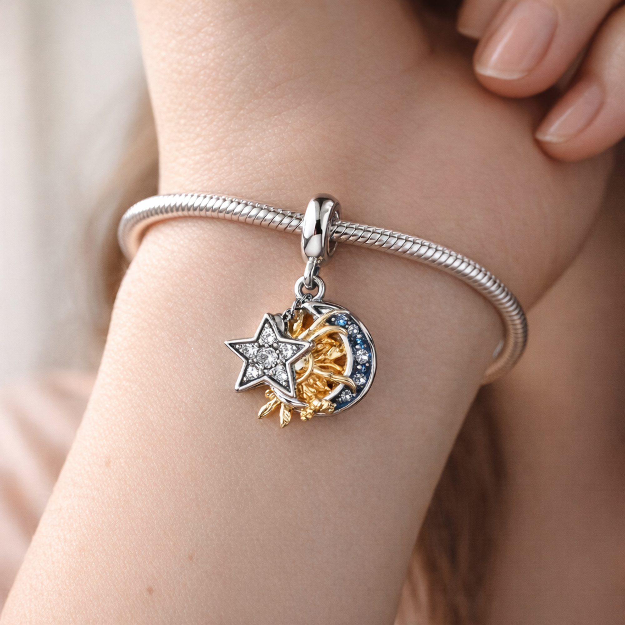 Two-tone Celestial Triple Dangle Charm — worn on wrist