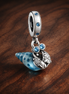 Glow-in-the-dark Hermit Crab Dangle Charm — display on walnut