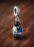 Blue Gem Dangle Charm - Deep Blue Gem Drop Charm — display on walnut