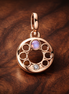 Rose Gold Plated Circle of Stones Charm - Rose Gold Plated Open Circle Stone Charm — display on walnut