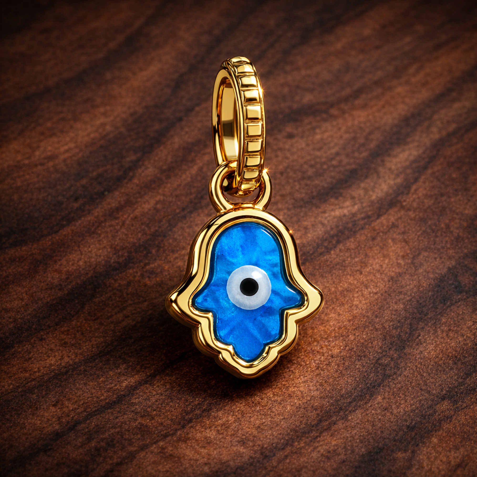 Opalescent Blue Hamsa Hand Dangle Charm — display on walnut