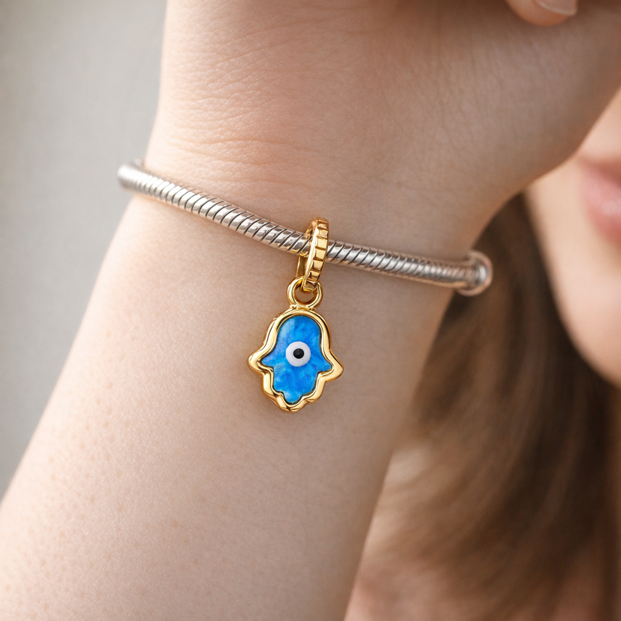 Opalescent Blue Hamsa Hand Dangle Charm — worn on wrist