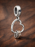 Heart Full of Hearts Dangle Charm — display on walnut