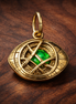 Gold Plated Eye Talisman Charm - Gold Plated Eye Talisman with Green Stone Charm — display on walnut