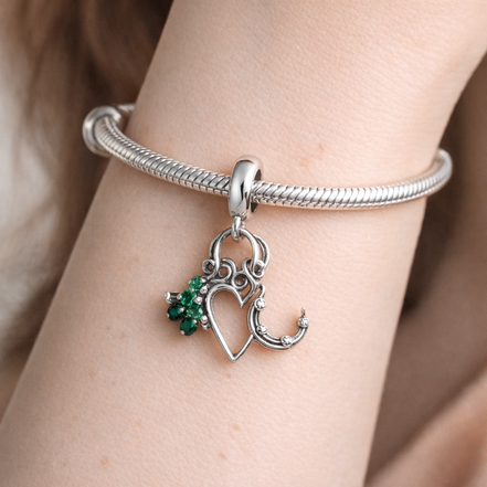 Four Leaf Clover, Heart and Horseshoe Triple Dangle Charm — worn on wrist