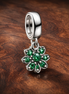 Four Leaf Clover Dangle Charm — display on walnut