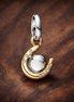 Gold Plated Horseshoe Love Charm - Gold Plated Horseshoe Love Dangle Charm — display on walnut