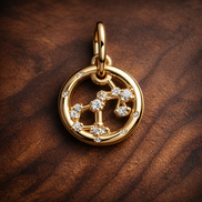 Aries Zodiac Charm - Gold Plated Aries Zodiac Charm — display on walnut