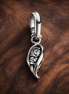 Pandora ME Sparkling Angel Wing Mini Dangle Charm — display on walnut
