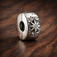 Sun Moon Star Bead - Silver Sun Moon Star Bead Charm — display on walnut