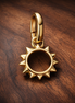 Gold Plated Sun Outline Charm - Gold Plated Open Sun Dangle Charm — display on walnut