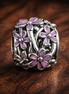 Openwork Purple Daisy Charm — display on walnut