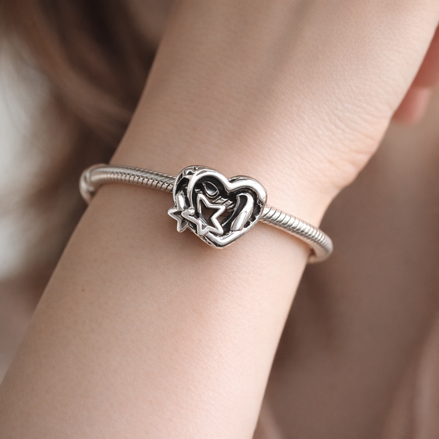 Openwork Family Heart & Star Charm — worn on wrist