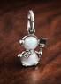 Opalescent Snowman Dangle Charm — display on walnut