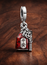 Lucky Amulet Double Dangle Charm — display on walnut