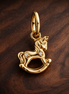 Rocking Unicorn Dangle Charm — display on walnut
