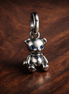 Movable Teddy Bear Dangle Charm — display on walnut