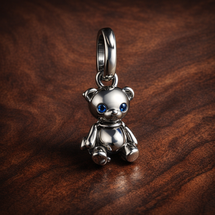 Movable Teddy Bear Dangle Charm — display on walnut