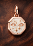 Rose Gold Plated Starry Disc Charm - Rose Gold Plated Starry Octagon Charm — display on walnut