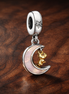 Two-tone Key & Moon Dangle Charm — display on walnut