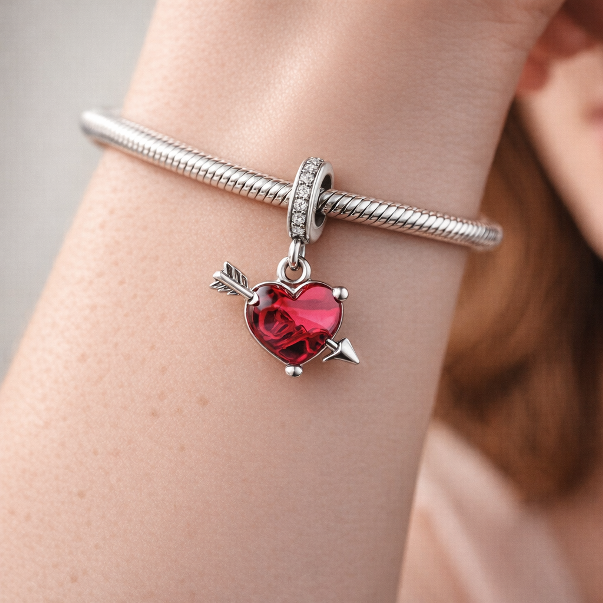 Red Heart & Arrow Murano Glass Dangle Charm — worn on wrist