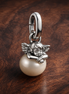 Pandora ME Cupid Mini Dangle Charm — display on walnut