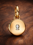 Openable & Engravable Love Locket Dangle Charm — display on walnut