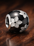 Black White Flower Bead - Black and White Floral Bead Charm — display on walnut