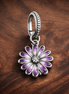 Purple Daisy Dangle - Purple Daisy Dangle Charm — display on walnut