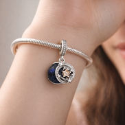 Two-tone Shooting Star Double Dangle Charm — worn on wrist