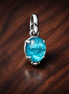Blue Murano Glass Balloon Dangle Charm — display on walnut