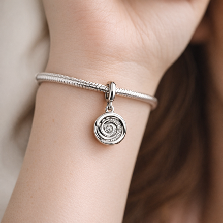 Silver Spiral Charm - Silver Spiral Galaxy Dangle Charm — worn on wrist