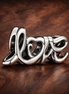 Love Script Charm - Silver Love Script Charm — display on walnut