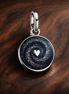Blue Evil Eye Disc - Blue Evil Eye Disc Charm — display on walnut