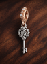 Storybook Key and Balloon Charm - Storybook Key and Balloon Charm — display on walnut