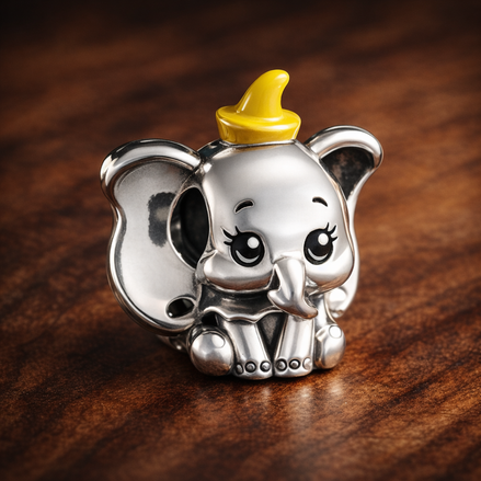 Disney Dumbo Charm — display on walnut