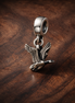 Hummingbird and Butterfly Charm - Hummingbird and Butterfly Charm — display on walnut