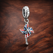 Union Jack Pinwheel Charm - Union Jack Pinwheel Charm — display on walnut