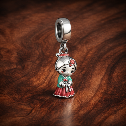 Holiday Doll Trio Dangle - Holiday Doll Trio Dangle Charm — display on walnut