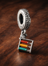 Tricolor Flag Dangle Charm - Tricolor Flag Dangle Charm — display on walnut